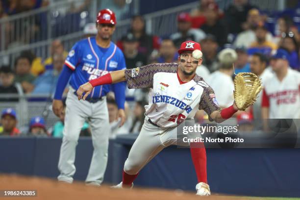 Alejandro Perez first baseman of Tiburones de la Guaira of Venezuela receives the ball in the first inning, during a game between Puerto Rico and...