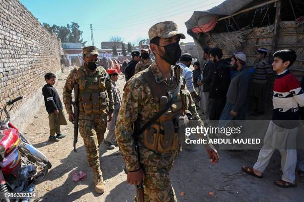Pakistani army personnel patrol outside a polling station during Pakistan's national elections in Peshawar on February 8, 2024. Millions of...