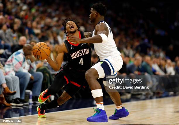 Jalen Green of the Houston Rockets drives to the basket against Anthony Edwards of the Minnesota Timberwolves in the second quarter at Target Center...