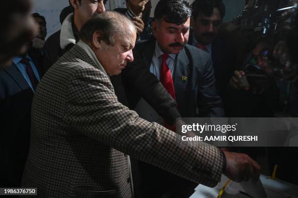 Pakistan's former Prime Minister and leader of the Pakistan Muslim League-Nawaz Nawaz Sharif casts his ballot to vote at a polling station during...