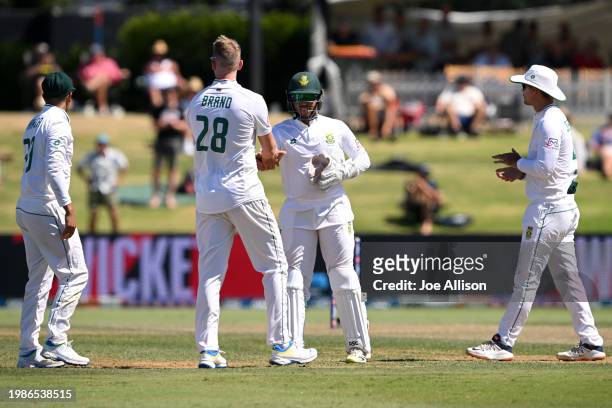 Neil Brand of South Africa celebrates with his team after dismissing Rachin Ravindra during day two of the First Test in the series between New...