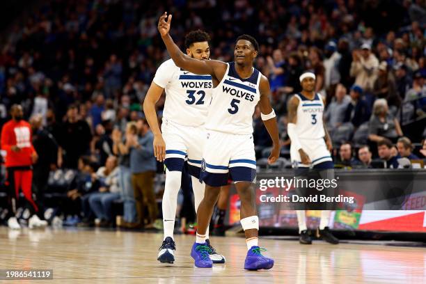 Anthony Edwards of the Minnesota Timberwolves celebrates his dunk against the Houston Rockets with teammate Karl-Anthony Towns in the fourth quarter...