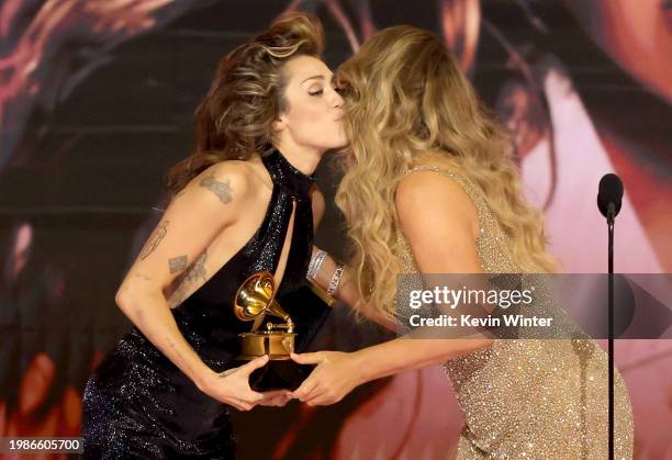 Miley Cyrus accepts the "Best Pop Solo Performance" Award for "Flowers" from Mariah Carey onstage during the 66th GRAMMY Awards at Crypto.com Arena...