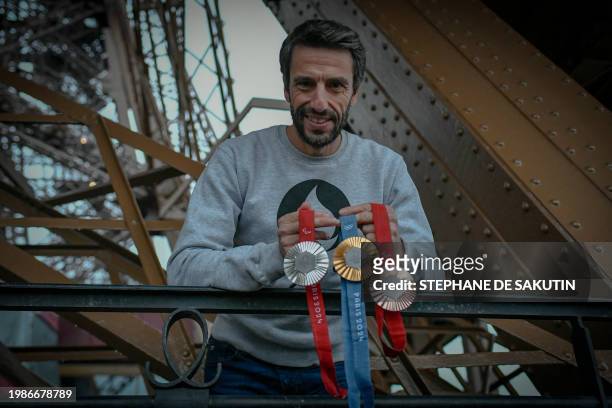 French President of the Paris Organising Committee of the 2024 Olympic and Paralympic Games Tony Estanguet poses with olympics 2024 medals on...