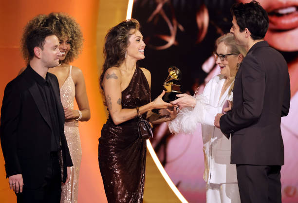 Miley Cyrus accepts the Record Of The Year award for “Flowers” from Meryl Streep and Mark Ronsononstage during the 66th GRAMMY Awards at Crypto.com...