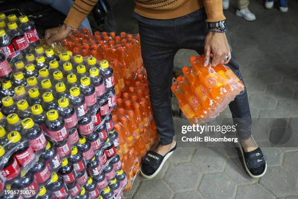 Worker moves crates of local soda brand Spiro Spathis at a supermarket in Cairo, Egypt, on Tuesday, Jan. 16, 2024. Driven by a wellspring of anger...