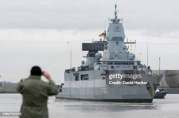 Family member of the German Navy frigate "Hessen" take pictures during the depart for deployment in the Red Sea on February 8, 2024 in Wilhelmshaven,...