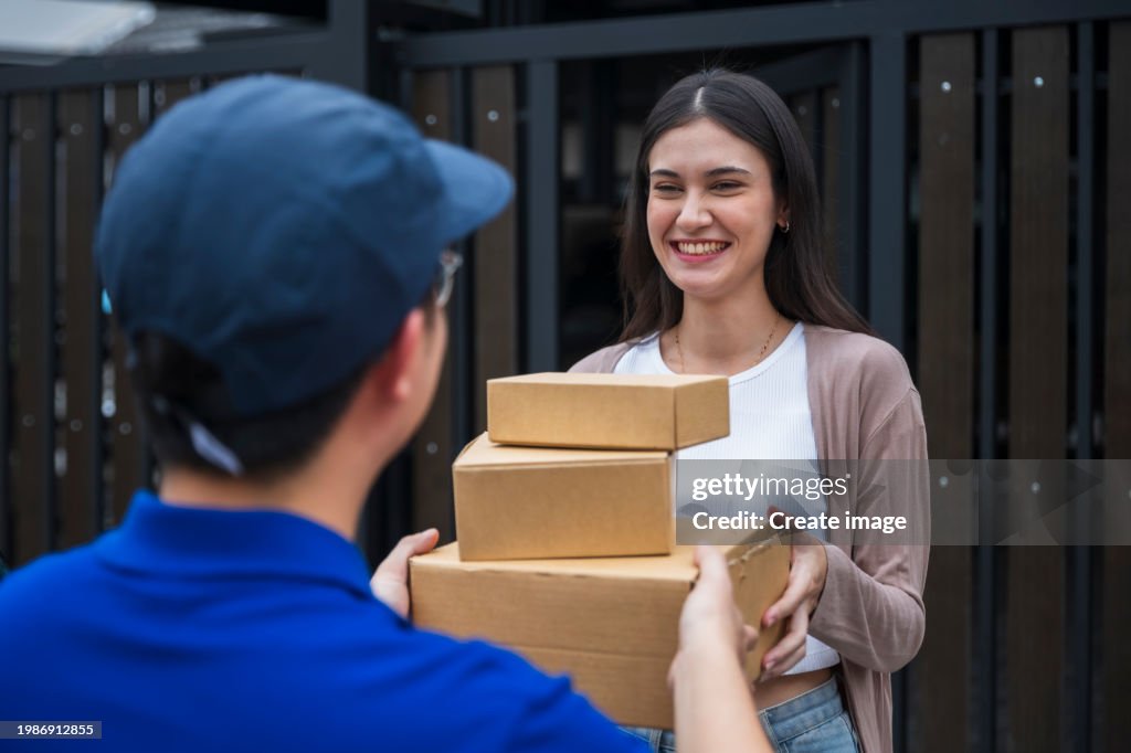 Male Delivery Driver Deliver A Parcel To Home Customer Business ...