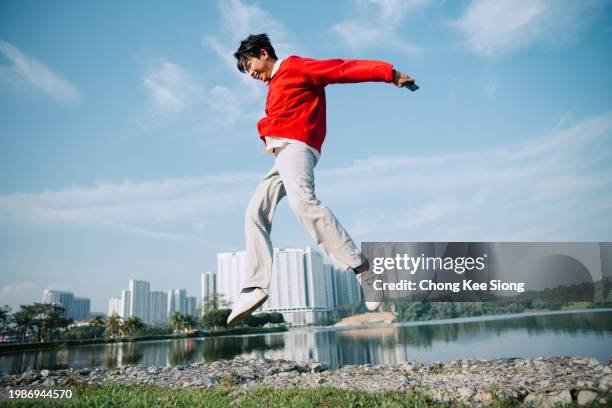 happy asian chinese with device. - smart casual stock pictures, royalty-free photos & images