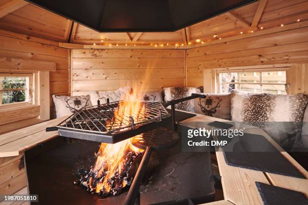 indoor, fire pit and empty room for holiday, vacation and getaway resort in an empty bungalow. flame, burning and cozy, winter retreat with furniture, decor or architecture for hospitality background - cozy stock pictures, royalty-free photos & images