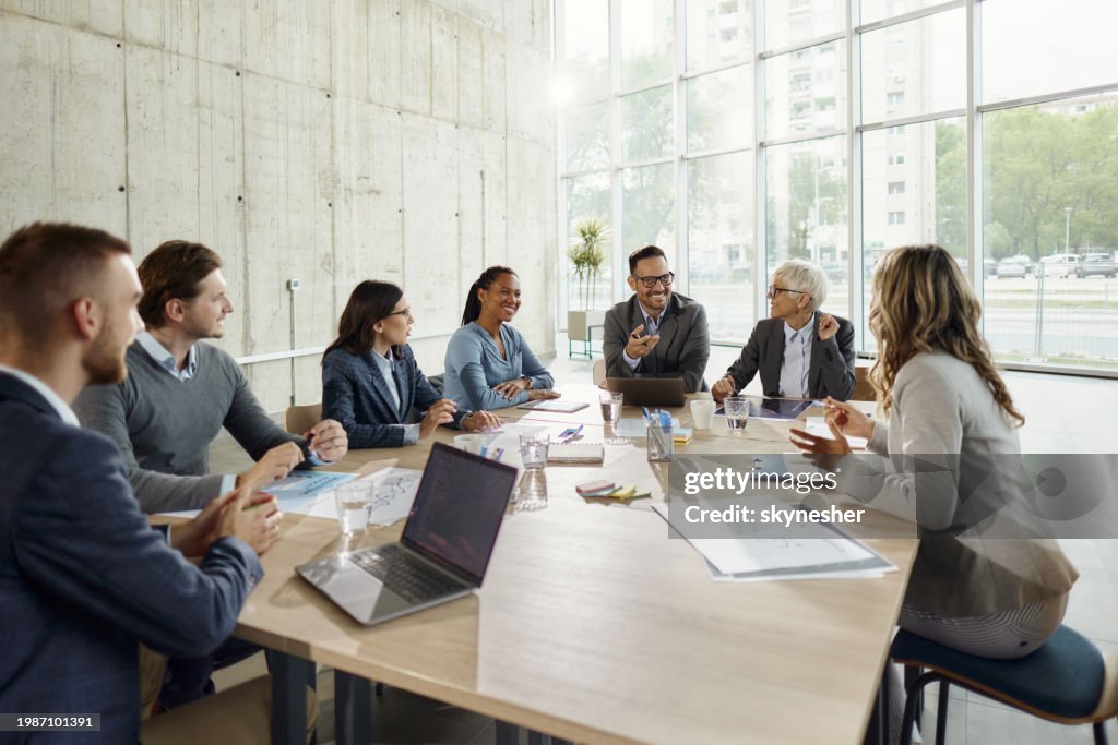 Team of happy entrepreneurs talking on a meeting in the office.