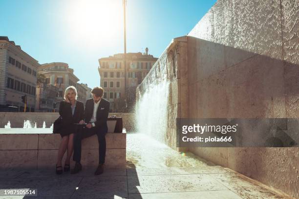 business man and woman out in the city - milan italy stockfoto's en -beelden