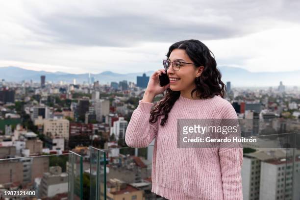 woman using her cellphone in mexico city - mexico stock pictures, royalty-free photos & images