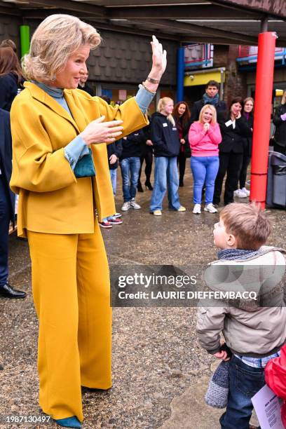 Queen Mathilde of Belgium gestures to children during a royal visit to the Mik'Ados project of organisation AniMagique, in Villers-la-Ville on...