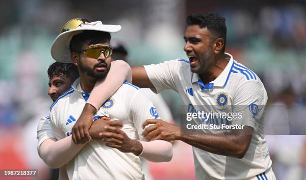 India fielder Shreyas Iyer celebrates with team mates Sarfaraz Khan and Ravi Ashwin after running out England captain Ben Stokes with a direct throw...