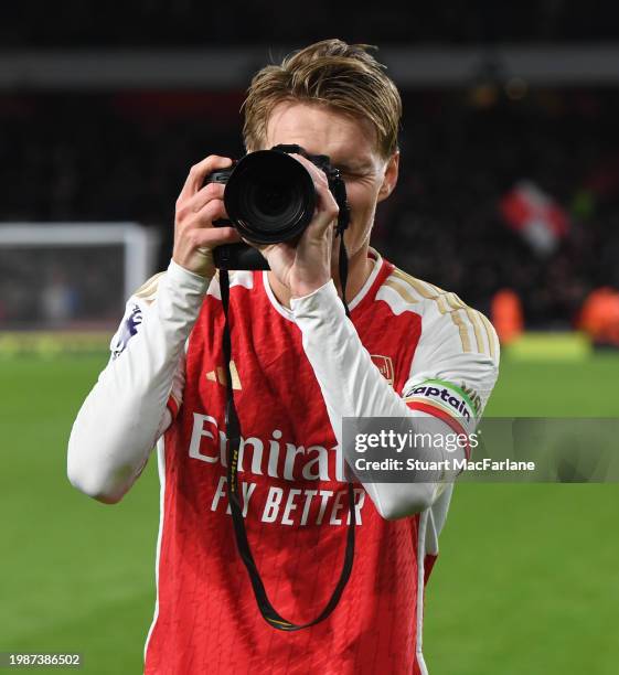 Arsenal captain Martin Odegaard takes pictures after the Premier League match between Arsenal FC and Liverpool FC at Emirates Stadium on February 04,...