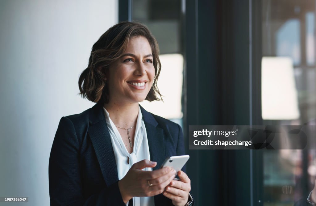 Business woman, phone and thinking by window for human resources ideas, solution and happy communication. Professional worker or employee with inspiration for mobile chat, online networking and email