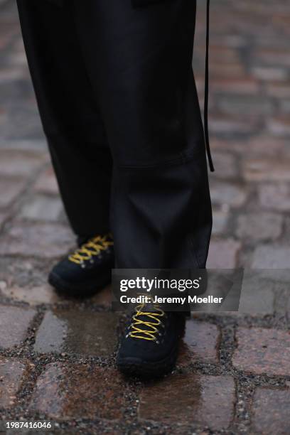 Jeanna Krichel seen wearing black leather straight leg pants and Hoka Tor Summit black sneakers, on January 26, 2024 in Berlin, Germany.