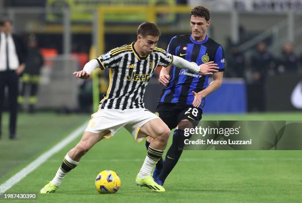 Kenan Yildiz of Juventus on the ball whilst under pressure from Benjamin Pavard of FC Internazionale during the Serie A TIM match between FC...