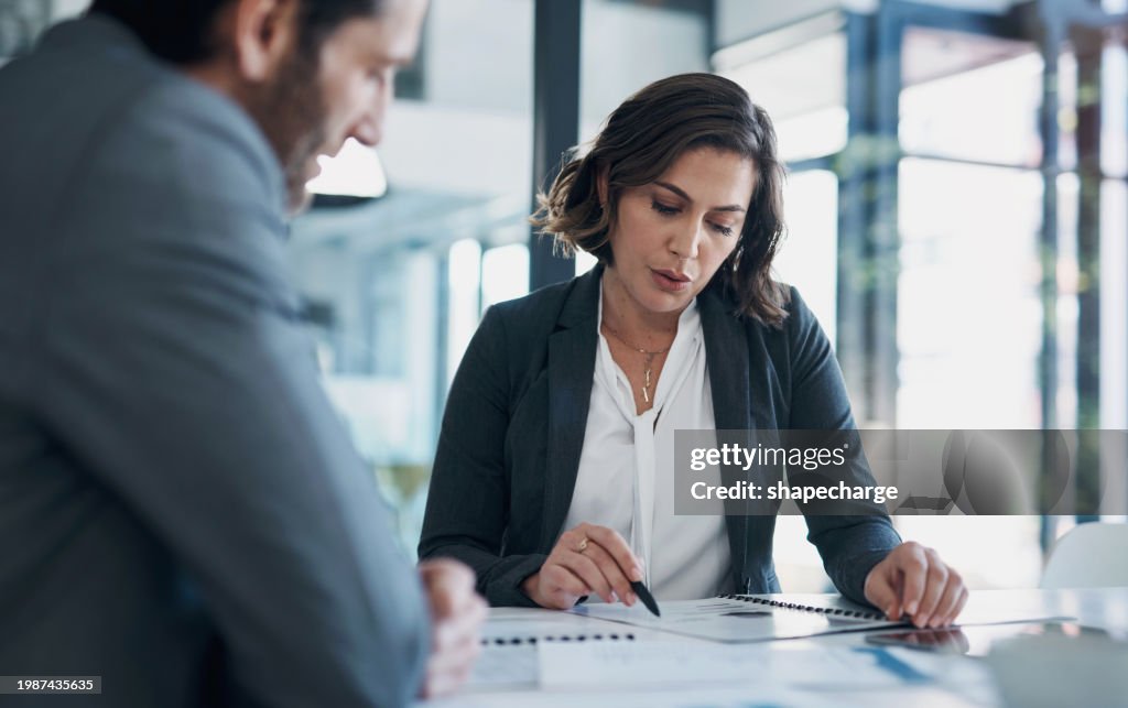 Business man, woman and paperwork with discussion for deal, agreement and proposal for b2b collaboration. People, staff and meeting with documents for financial strategy, stats and feedback in office