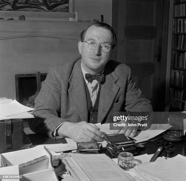 Welsh scientist and archaeologist Dr Glyn Daniel who was voted Television Personality of the Year in 1955, seated in his office at St John's College,...