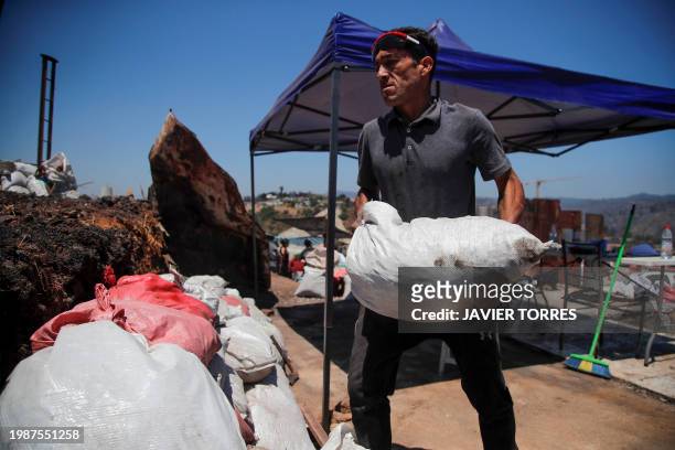 Humberto Guerra removes debris from the site of his house burned by forest fires in the Poblacion Monte Sinai neighborhood in Viña Del Mar, Chile, on...