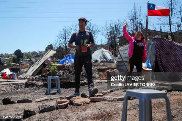 Humberto Guerra and Brenda Bustos are pictured at the site of their house burned by forest fires in the Poblacion Monte Sinai neighborhood in Viña...