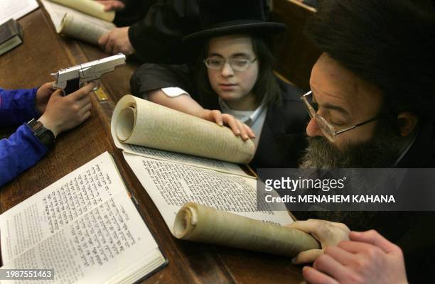 Ultra Orthodox Jews from the Wiznitz Hassidim group reads the Ester scrolls at the synagogue in the Israeli town of Beni Brak near Tel Aviv 13 March...