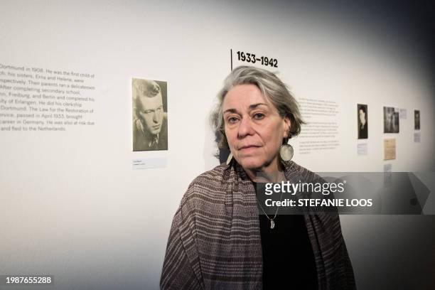 Simone Bloch, daughter of Curt Bloch poses for a photo next to a picture of her father during a preview of the exhibition "My Verses Are like...