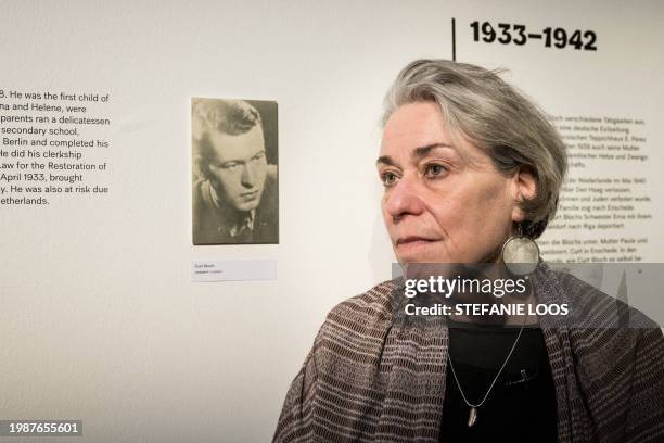 Simone Bloch, daughter of Curt Bloch poses for a photo next to a picture of her father during a preview of the exhibition "My Verses Are like...