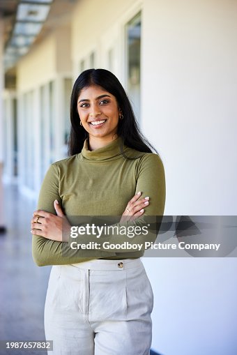 Young businesswoman smiling in the hallway of a modern office Young businesswoman smiling in the hallway of a modern office