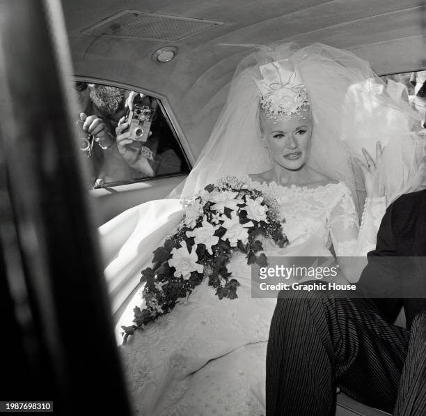 American actress and singer Connie Stevens in her wedding dress as she sits in the wedding car outside St Francis De Sales Church in the Sherman Oaks...