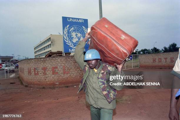 Senegalese UN military observer of the United Nations Assistance Mission for Rwanda carries a suitcase on June 22, 1994 in Kigali before UN military...