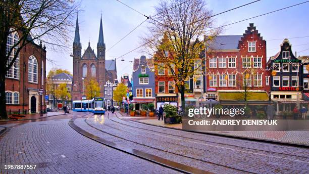 tram running, amsterdam, netherlands. - amsterdam sunrise stock pictures, royalty-free photos & images