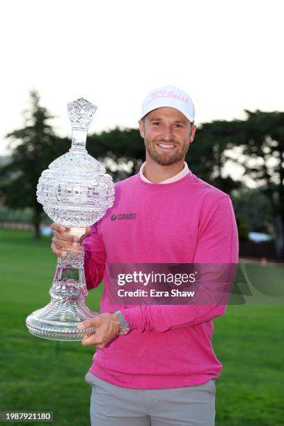Wyndham Clark of the United States poses with the trophy after winning the AT&T Pebble Beach Pro-Am at Pebble Beach Golf Links on February 05, 2024...