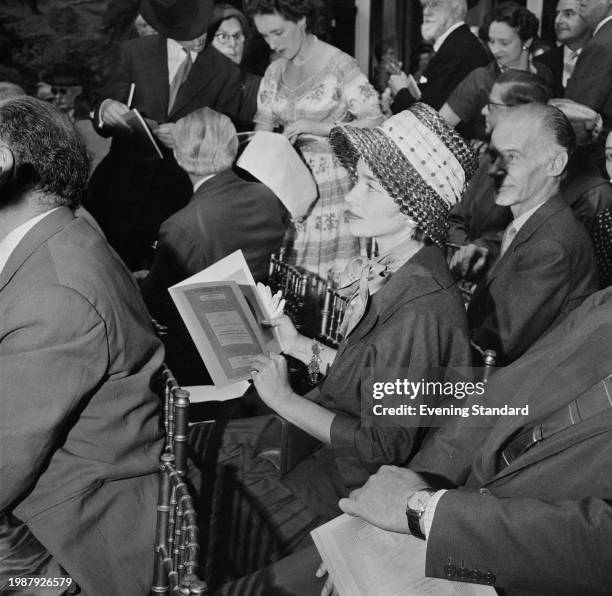 Contemporary Art Society Organising Secretary, Pauline Vogelpoel seated with a catalogue at the The William Weinberg collection sale of paintings,...