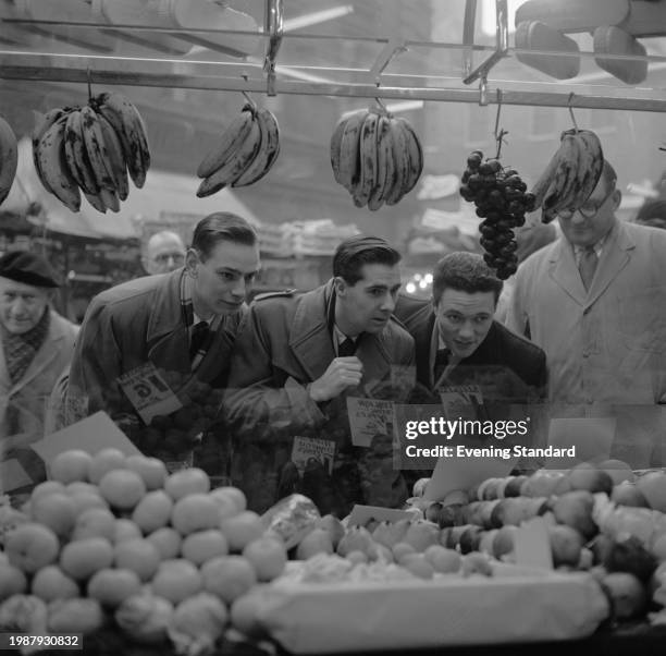 Three young husbands-to-be, Malcolm Madgewick, Martin Smith and Malcom Brogin, visit a fruit stall at a greengrocers to learn how to shop, January...