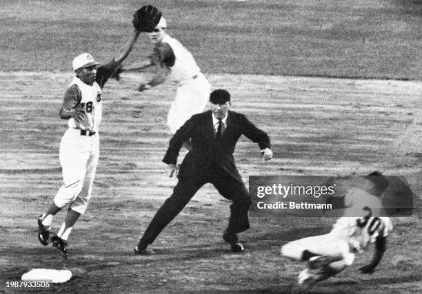 After gaining a base on balls, Maury Willis steals second base in the Dodgers' explosive four run 4th inning. The pitcher's throw to the Leo Cardenas...