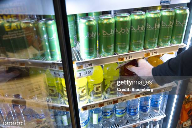 Shopper takes a bottle of Gatorade from a refrigerator at a supermarket in Clifton Park, New York, US, on Friday, Feb. 2, 2024. PepsiCo Inc. Is...