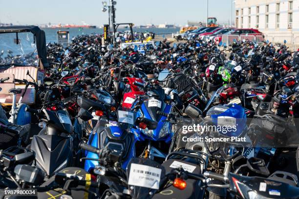 Scooters and motorcycles seized from the streets are stored at a tow yard in Brooklyn on February 05, 2024 in New York City. The scooters are...