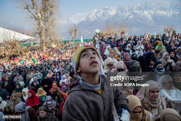 Muslim boy looks on as the head cleric displays the holy relic believed to be a hair from the beard of Prophet Muhammad on the occasion of...