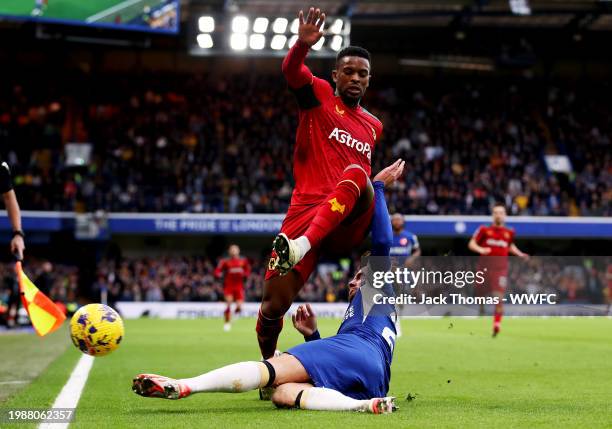 Nelson Semedo of Wolverhampton Wanderers is challenged by Ben Chilwell of Chelsea FC during the Premier League match between Chelsea FC and...