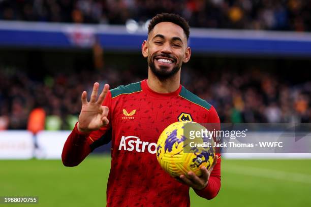 Matheus Cunha of Wolverhampton Wanderers poses with the match ball after scoring a hat-trick during the Premier League match between Chelsea FC and...