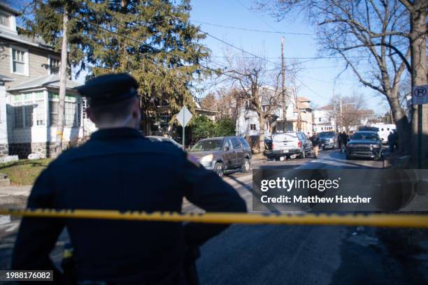 Police tape off the area around a home that was set ablaze and where at least six people remain unaccounted for on February 8, 2024 in East...