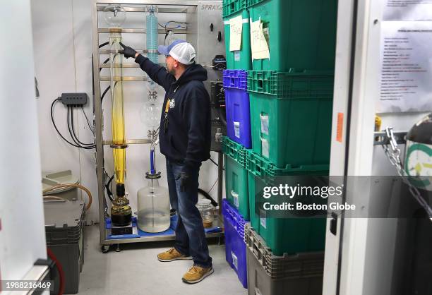 Wareham, MA Jesse Pitts checks on the extraction procedure of the cannabis plant that removes the crude CBD oil containing Delta-9 at Trade Roots, a...