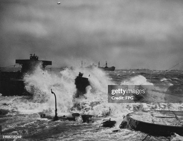 View of ships deliberately scuttled off Omaha Beach to provide makeshift breakwaters, during the storm of 19th-21st June 1944.