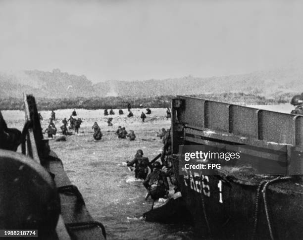 Troops hit the water after leaving a landing barge during the D-Day invasion of Normandy, France, 6th June 1944.