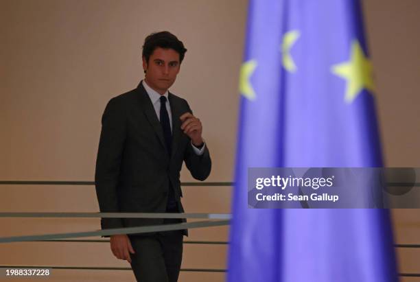 New French Prime Minister Gabriel Attal and German Chancellor Olaf Scholz arrive to speak to the media during talks at the Chancellery on February...