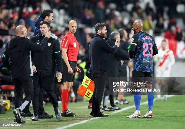 Quique Sanchez Flores, Head Coach of Sevilla FC, speaks with Marcao of Sevilla FC during the LaLiga EA Sports match between Rayo Vallecano and...