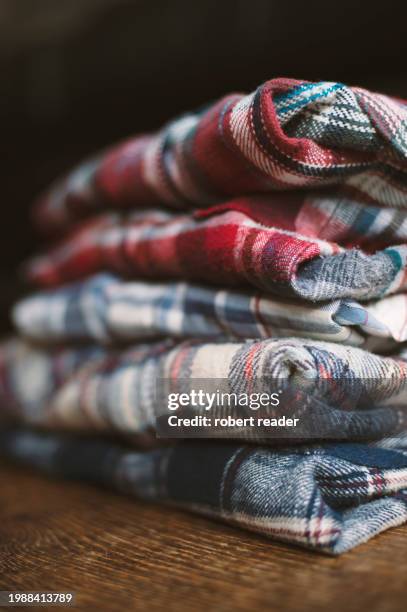 stack of plaid check flannel shirts - embellished shirt stock pictures, royalty-free photos & images